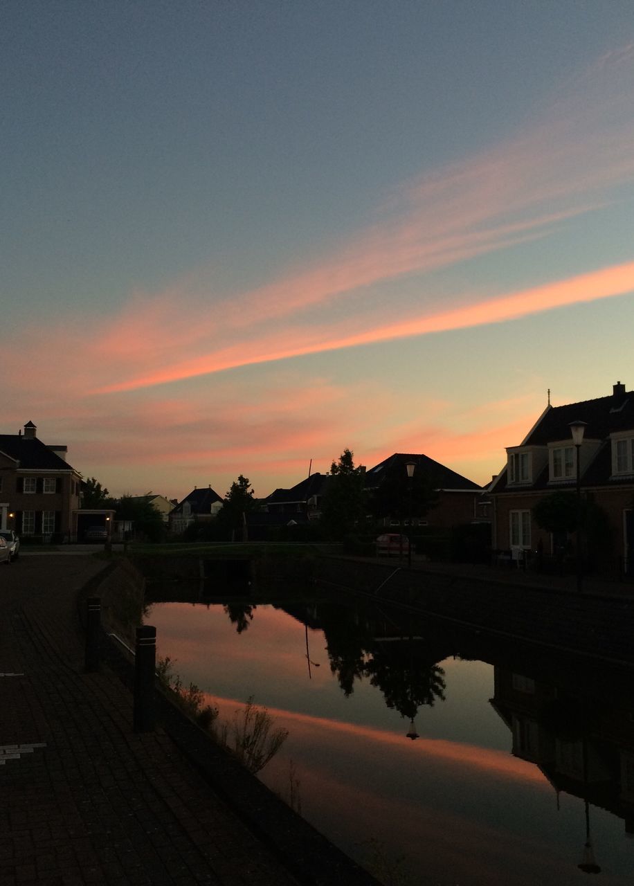 architecture, building exterior, built structure, water, reflection, sunset, sky, orange color, city, cloud - sky, standing water, waterfront, dark, calm, canal, outdoors, no people, city life, exterior