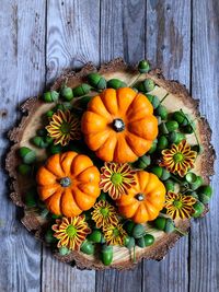 Directly above shot of pumpkins with acorns on wooden table