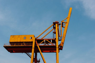 Low angle view of metallic tower against sky