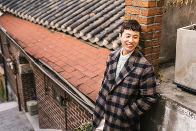 Portrait of a smiling young man standing outdoors