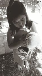 Close-up of cute girl sitting outdoors