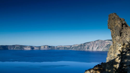 Scenic view of sea against clear blue sky