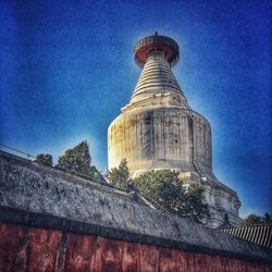 Low angle view of lighthouse against blue sky