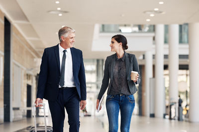 Man and woman walking in corridor