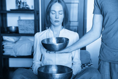 Portrait of young woman holding food at home