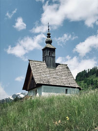 Low angle view of building on field against sky