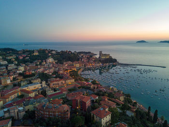 Aerial view of cityscape by sea against sky