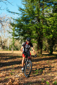 Man riding bicycle in forest