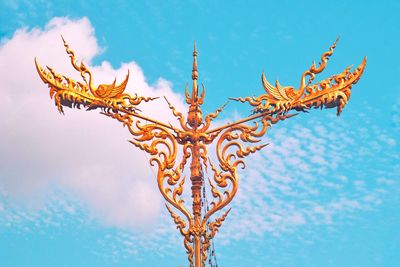 Low angle view of a street lamp against blue sky