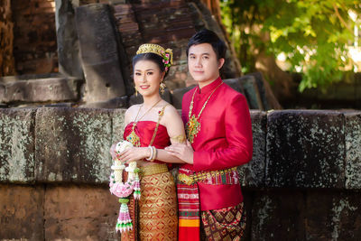 Portrait of smiling couple standing outdoors