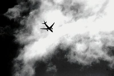 Low angle view of airplane flying in sky