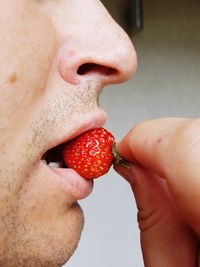 Close-up of hand holding strawberry