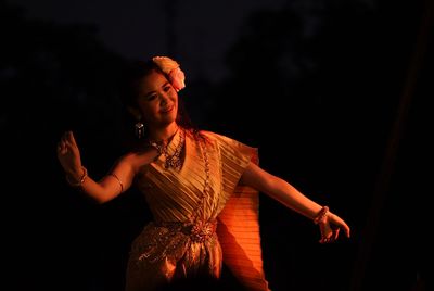 Young woman looking away at night