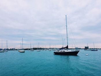 Sailboats sailing in sea against sky