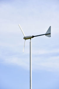 Low angle view of wind turbine against sky