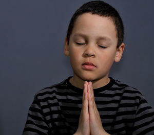 Close-up of boy against wall