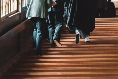 Low section of people walking on staircase