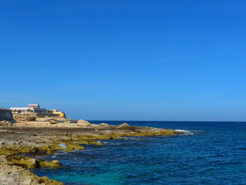 Scenic view of sea against clear blue sky