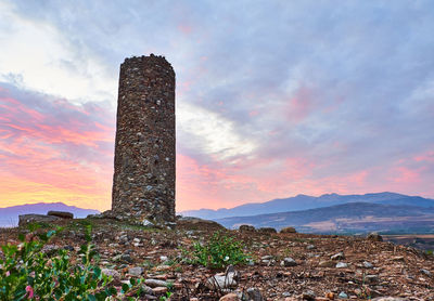 Scenic view of land against sky during sunset