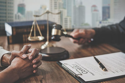 Judge sitting with client at table in office