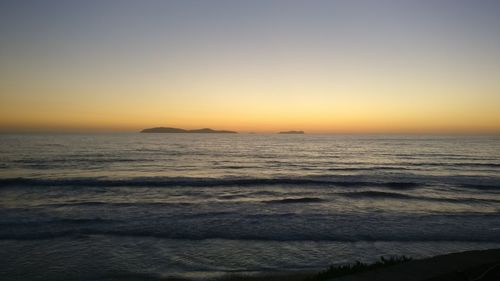 Scenic view of sea against clear sky during sunset