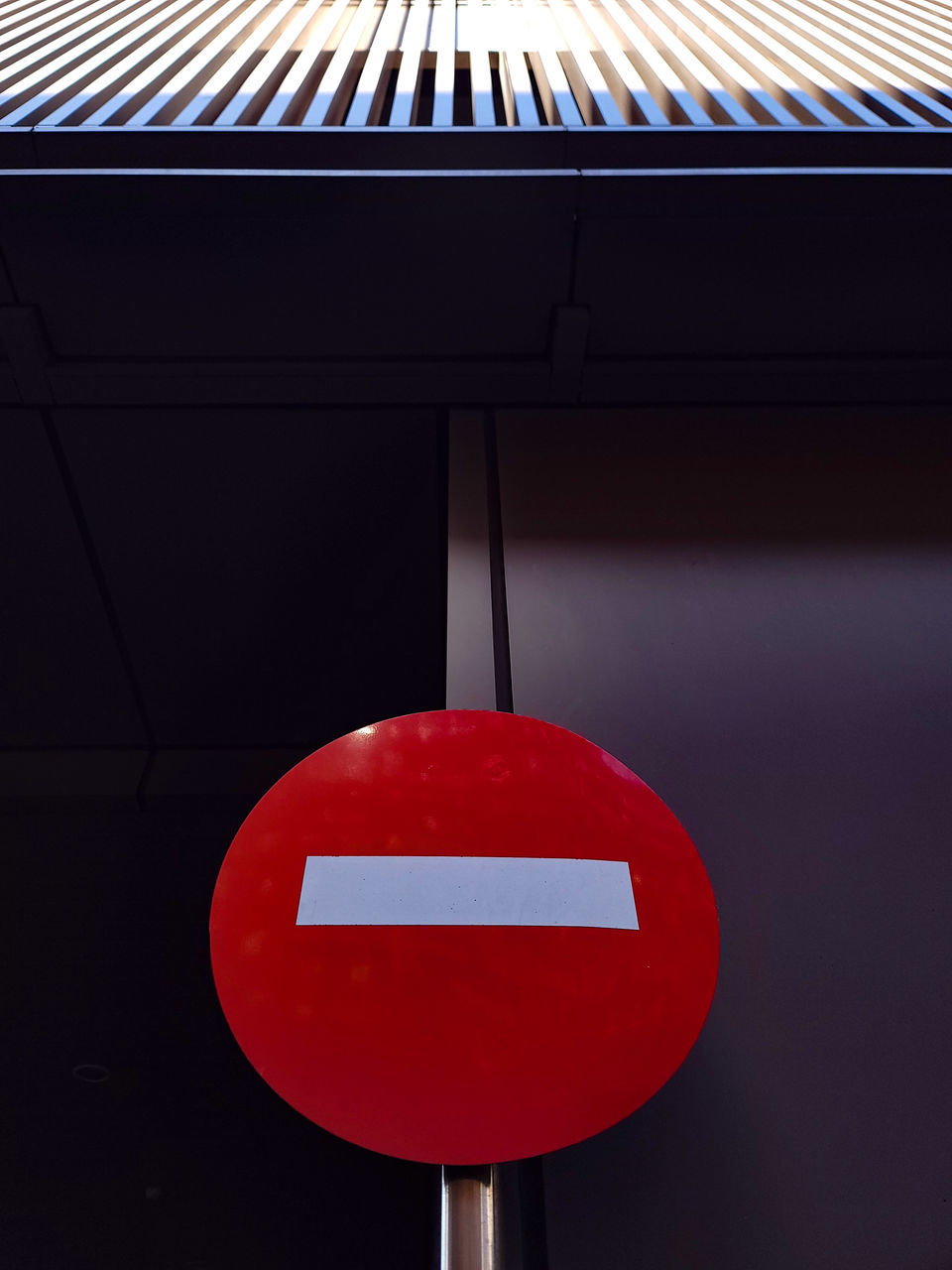 red, sign, communication, no people, signage, lighting, road sign, warning sign, light, guidance, indoors, circle, stop sign, close-up, shape, architecture, day