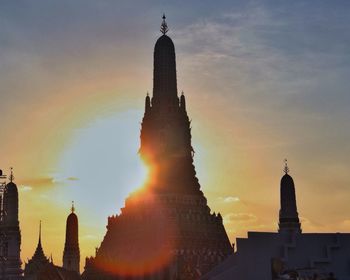 Low angle view of buildings against sky at sunset