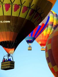 Hot air balloons flying against clear sky