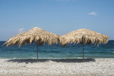 Scenic view of beach against blue sky