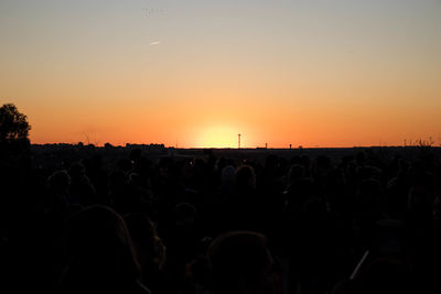 Silhouette people against sky during sunset