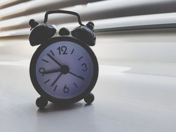 Close-up of clock on table