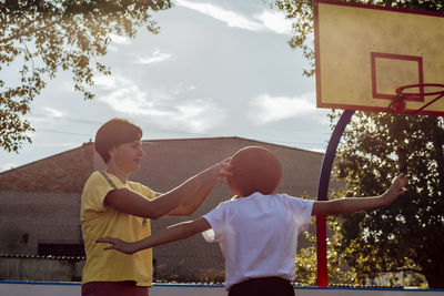 Ball head, heart full, young player embraces unique perspective on the basketball court with his mom