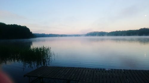 Scenic view of lake against sky at sunset