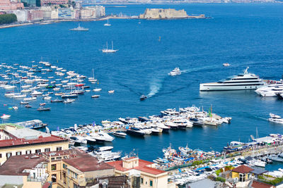 High angle view of sailboats moored on harbor in city