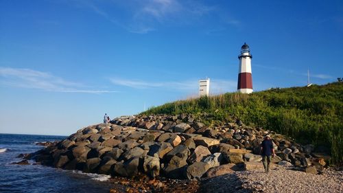 Montauk point light on shore against sky