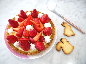 High angle view of strawberry tart in plate on table