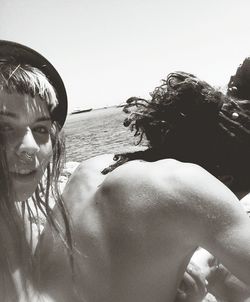 Close-up of woman on beach against sky