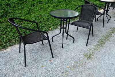 High angle view of empty chairs and table in park