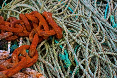 Ropes and rusty chair at harbor