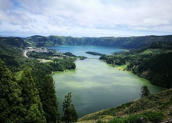 Panoramic view of lake and trees against sky