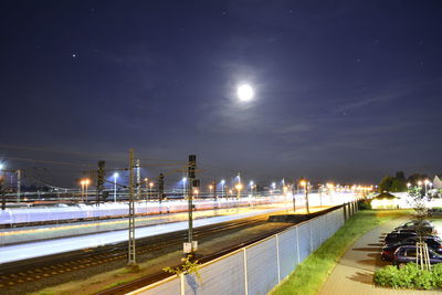 Illuminated city against sky at night