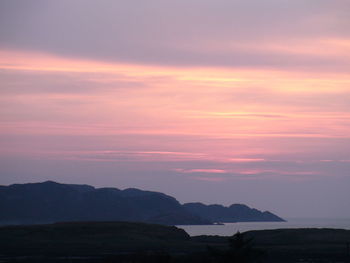 Scenic view of mountains against sky at sunset