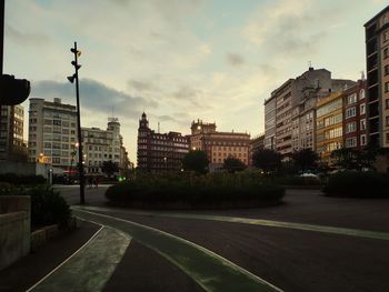 City street by buildings against sky