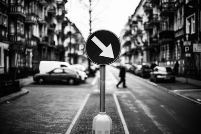 Close-up of road sign on street in city