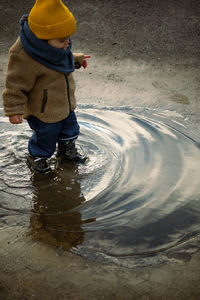 Rear view of man standing in water