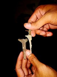 Close-up of people holding metal