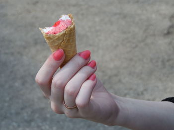 Close-up of hand holding ice cream cone