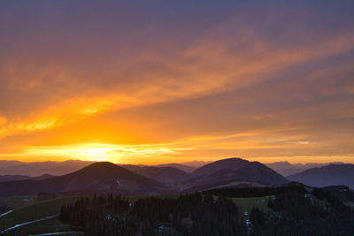 Scenic view of silhouette mountains against sky during sunset