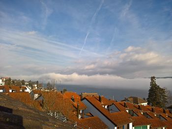 High angle view of houses against cloudy sky