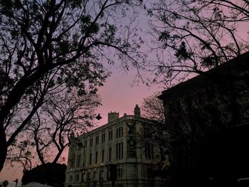 Low angle view of building against sky at dusk